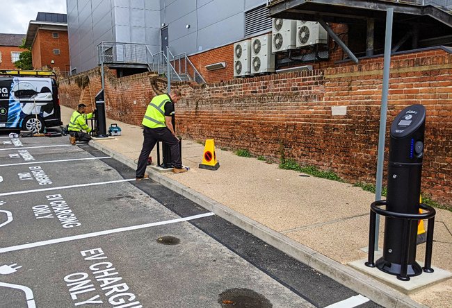 Two people in high-vis installing EV charging points in the Aylesbury Waterside North car park