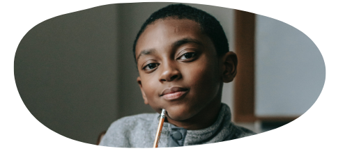 Boy with pencil looking pensive