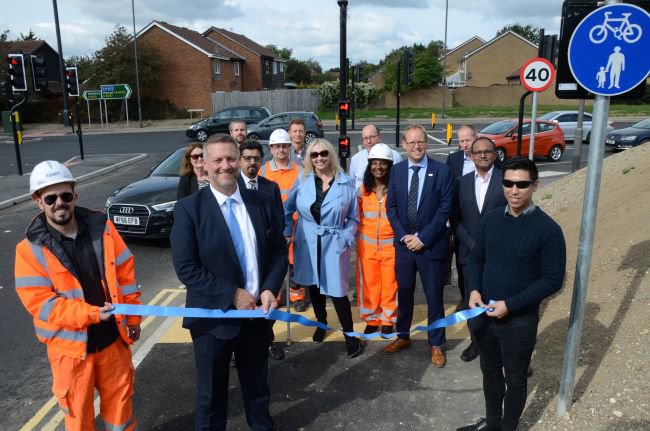 Images showing Buckinghamshire Council Cabinet Member for Transport, Steven Broadbent, cutting a ribbon to declare the new Crest Road junction open for business.
