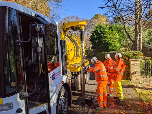 Steven Broadbent (centre), Cabinet Member for Transport, watching one of the gully cleaning operations.