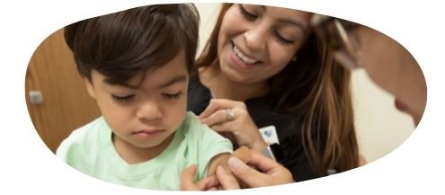 Mother and son seeing their health visitor