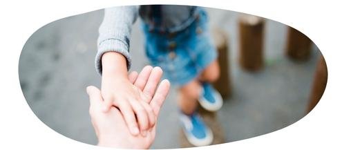 Parent holding a child's hand