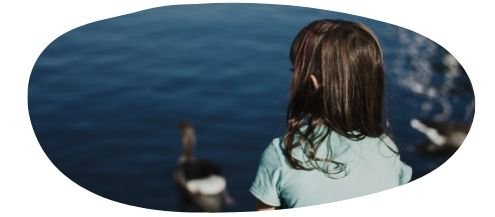 Young girl looking at the sea